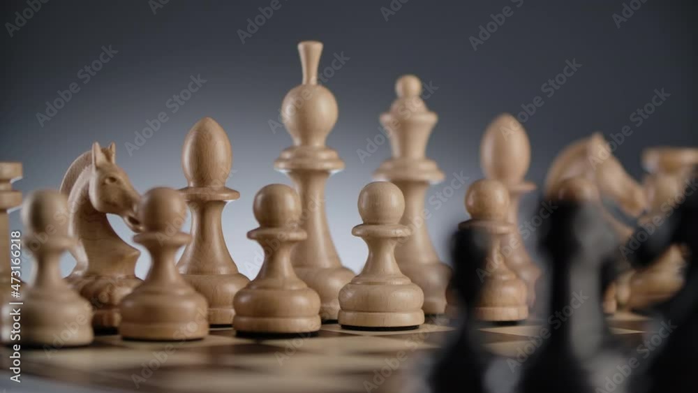 Close-up of wood chessboard with lines of white and black wooden chess figures in a row ready to play with blurred foreground and background. Slider move. 4K Close-up of wood chessboard with lines of white and black wooden chess figures in a row ready to play with blurred foreground and background. Slider move. 4K