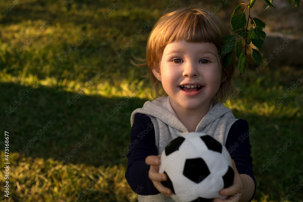 Cute little child plays football soccer. Cute little child plays football soccer.