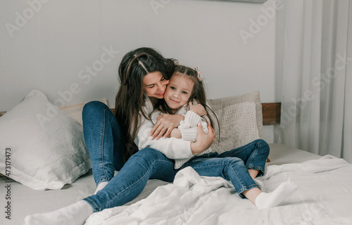 Happy loving family. Mother and her baby girl daughter play and cuddle