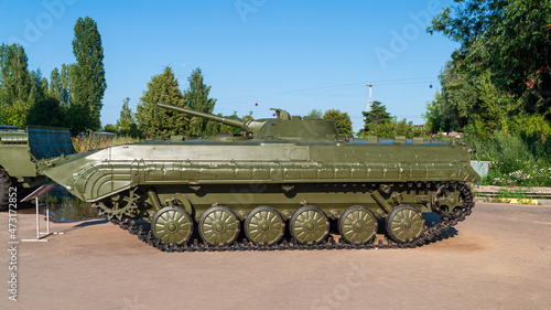 Infantry fighting vehicle. BMP 1 on display in victory park nizhny Novgorod. Standing on the asphalt against the backdrop of green trees and blue sky. High quality photo photo