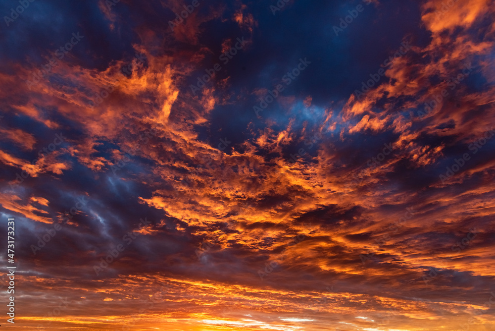 Colorful cloudy sky at sunset. Dramatic sunset sky with clouds. Sky texture, nature background.