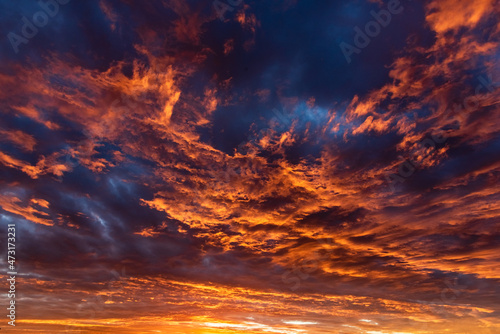 Colorful cloudy sky at sunset. Dramatic sunset sky with clouds. Sky texture, nature background. © TomPhotos