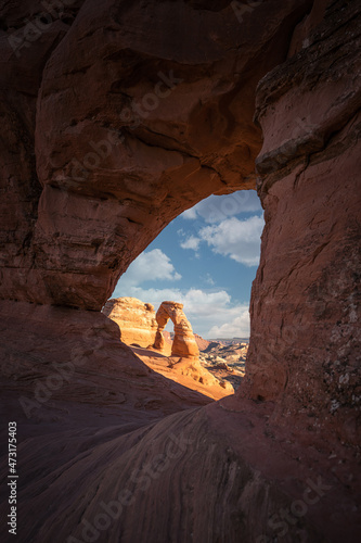 delicate arch in Arches National Park with clouds and clouds