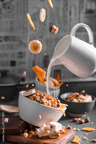 Musli with milk and fruits levitating objects