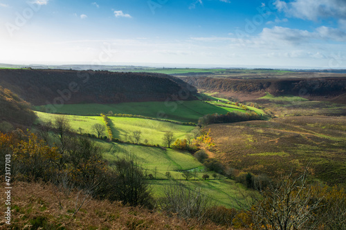 View of valley in autumn under clear sky from a hiking path in Yorkshire England