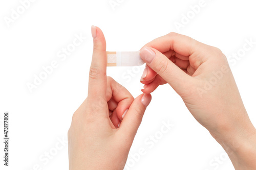 Woman applying bandages on finger white background isolate