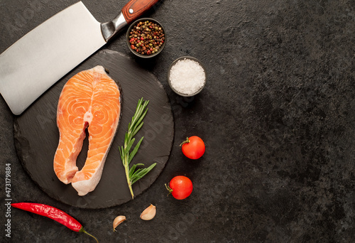 raw salmon steak on stone background with copy space for your text
