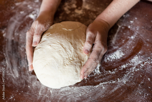 Female hands making dough. Dough kneading process. Dough based on natural sourdough. Wheat dough. Fermentation.