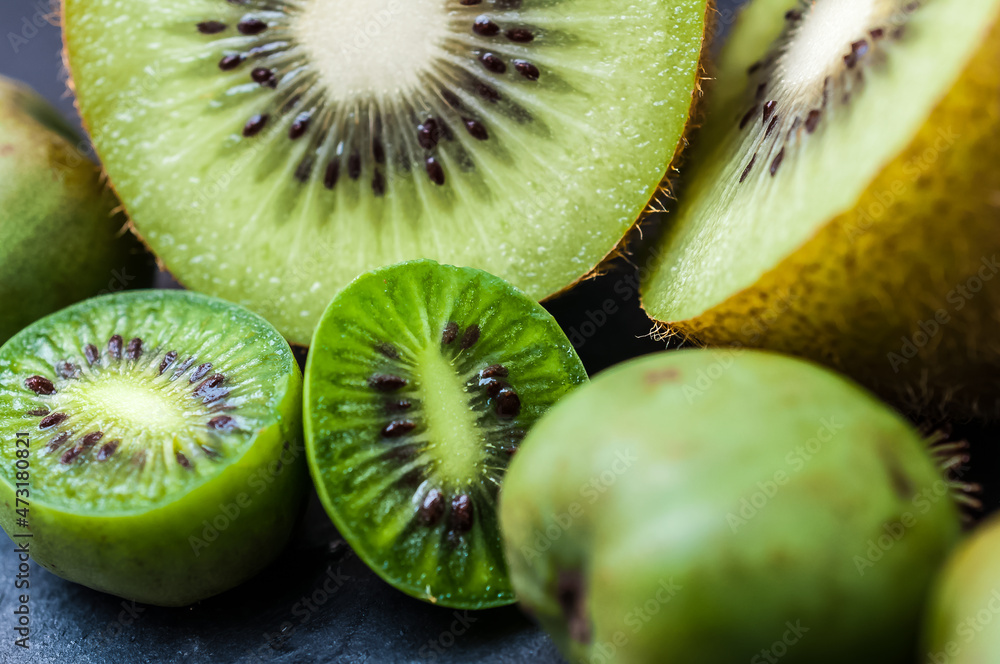 Fototapeta premium fresh yellow kiwi fruits on a slate plate