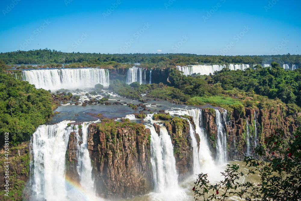 Beautiful view of a large waterfall at Iguazu Falls from brazilian side, one of the Seven Natural Wonders of the World - Foz do Iguaçu, Brazil Beautiful view of a large waterfall at Iguazu Falls from brazilian side, one of the Seven Natural Wonders of the World - Foz do Iguaçu, Brazil