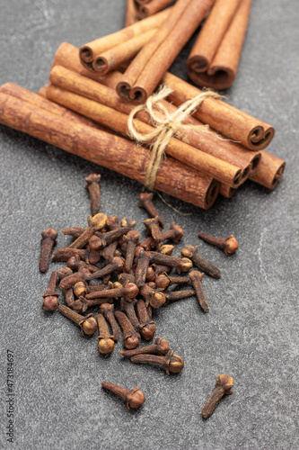 Cinnamon sticks tied with thread. Dry buds of spice cloves.