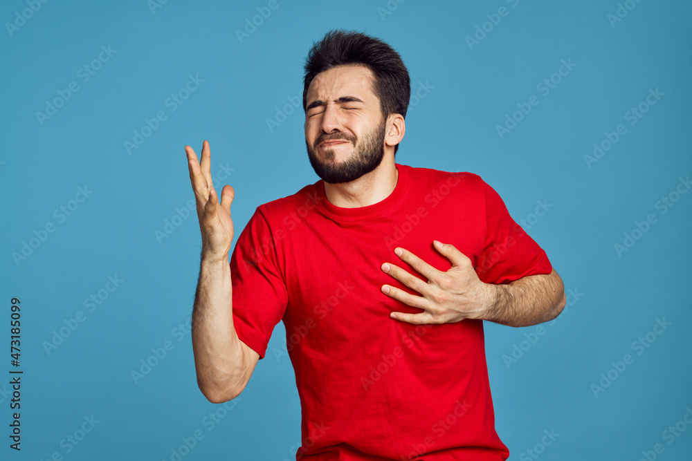 man in red t-shirt health problems emotions symptoms blue background man in red t-shirt health problems emotions symptoms blue background