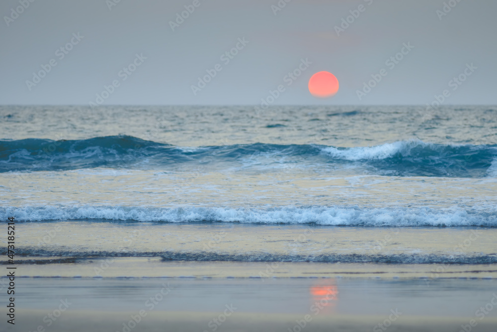 Sunset in the ocean against the backdrop of waves. Goa coastline Sunset in the ocean against the backdrop of waves. Goa coastline
