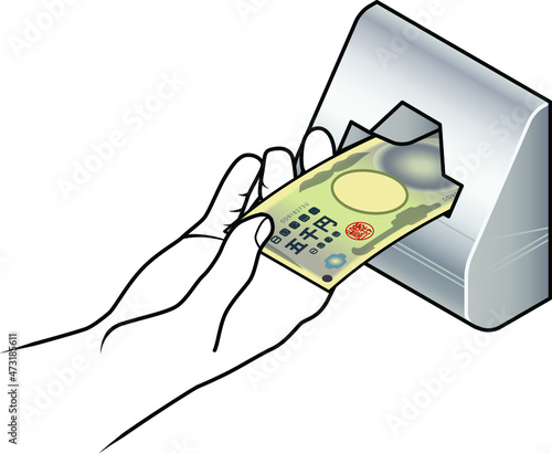Hand inserting a Japanese bank note into a vending machine slot.
