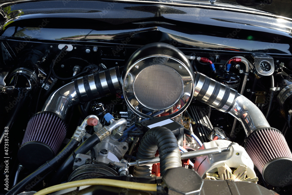 AUTOMOTIVE: Under the hood view of a Dual Carb Engine with shiny parts and fluted filters. AUTOMOTIVE: Under the hood view of a Dual Carb Engine with shiny parts and fluted filters.