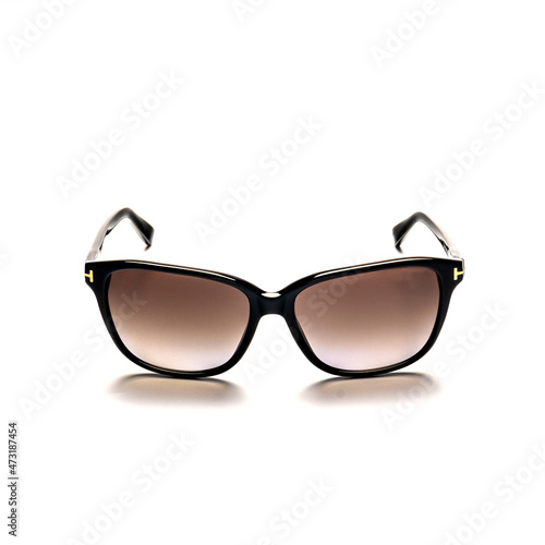 Black, women's sunglasses on a white background close-up.
