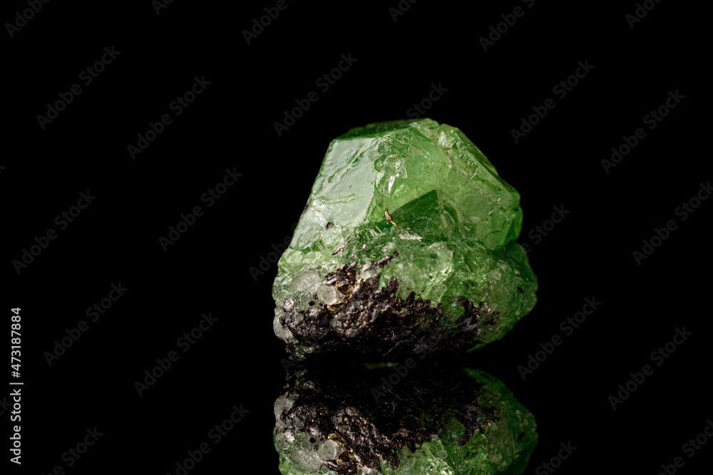 macro mineral stone Demantoid on a black background