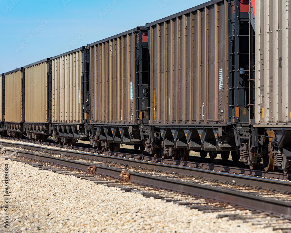 Freight train cars on railroad tracks. Supply chain, rail transportation and shipping concept