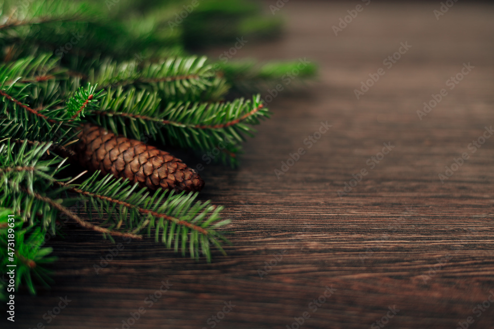 Decoration of Christmas Tree Branches on a Brown Background with CopySpace Decoration of Christmas Tree Branches on a Brown Background with CopySpace