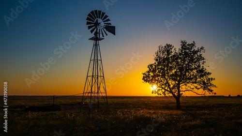 Silhouetted windmill at sunset