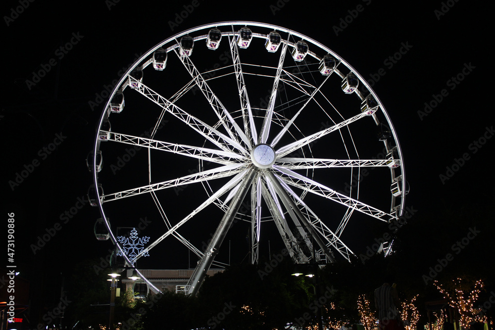 A large observation Ferris wheel illuminated at night in the Victoria and Albert Waterfront, Cape Town, Western Cape, South Africa
