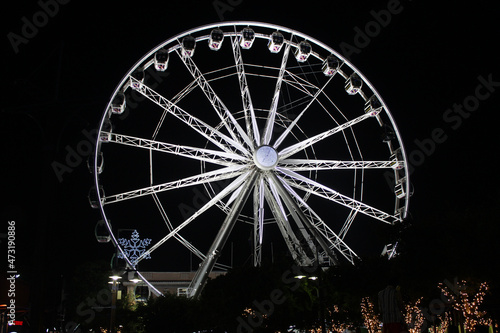 A large observation Ferris wheel illuminated at night in the Victoria and Albert Waterfront, Cape Town, Western Cape, South Africa © Oenz