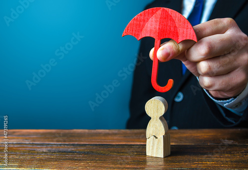Insurance agent holds an umbrella over a men with a crack. Rehabilitation after trauma, drugs, alcohol. Health and life insurance. Psychological help. Social support. Recovery. Protectorate, patronage