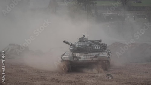 Armored combat vehicle moving on the sand runs over the car, runs into the car. Combat war technology concept.