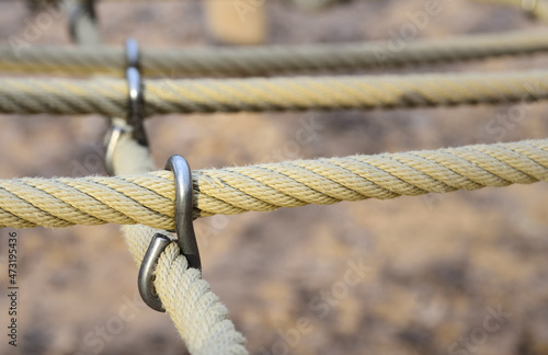 close up of ropes tied together with metal clasps