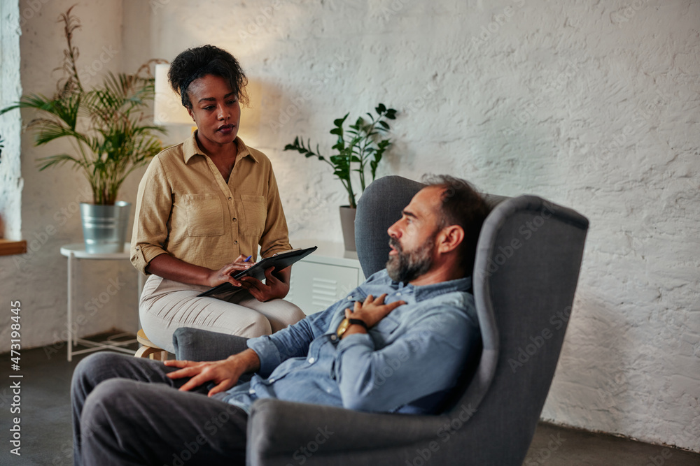 Mid age man having one counseling meeting with psychotherapist Mid age man having one counseling meeting with psychotherapist