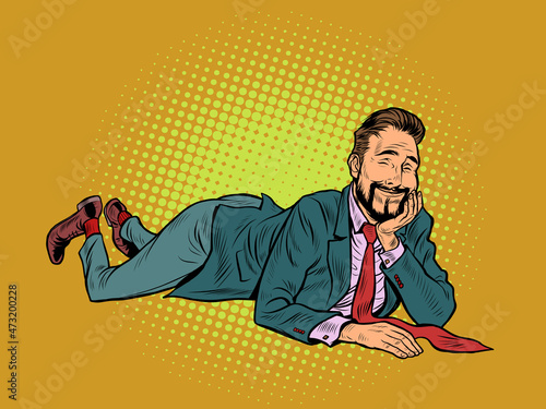 The joyful businessman is lying. Relaxed funny pose. Peace and relaxation