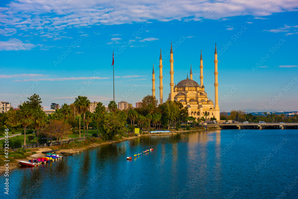 Sabanci Central Mosque (Turkish: Sabanci Merkez Cami) and Seyhan River in Adana, Turkey. Turkey's largest mosque with blue sky.