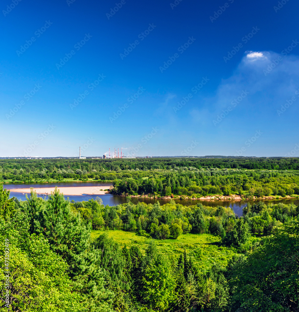 view of the forest and the river on a sunny summer day