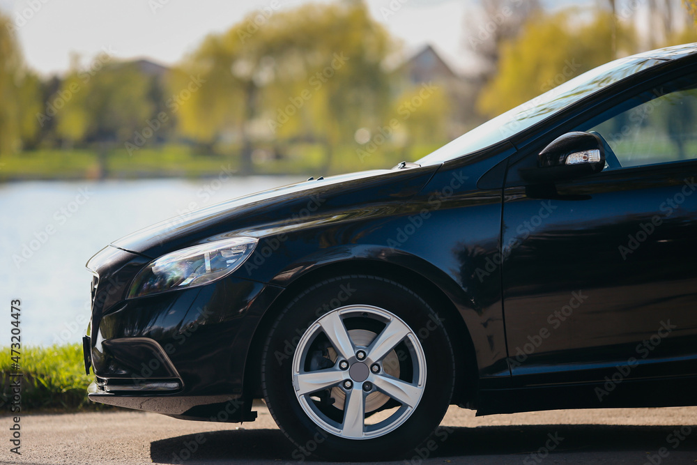 Wheels and front of a modern car outdoors. Wheels and front of a modern car outdoors.