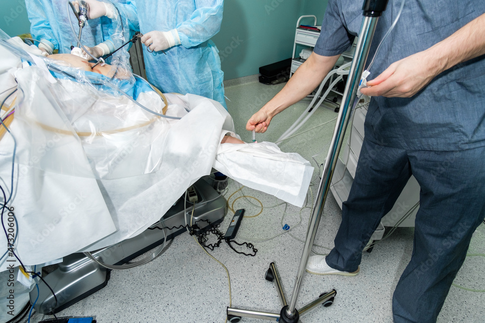 The doctor injects anesthesia into the patient's arm during surgery