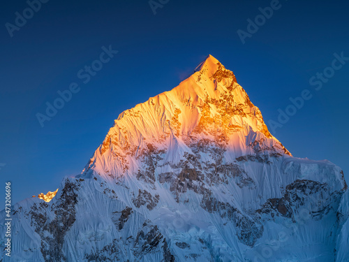 view to golden mountains peak in sun light under blue sky with copy space