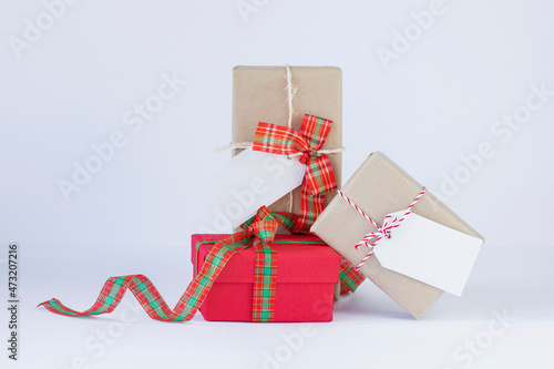 Christmas present boxes with  white tags on white background stock photo