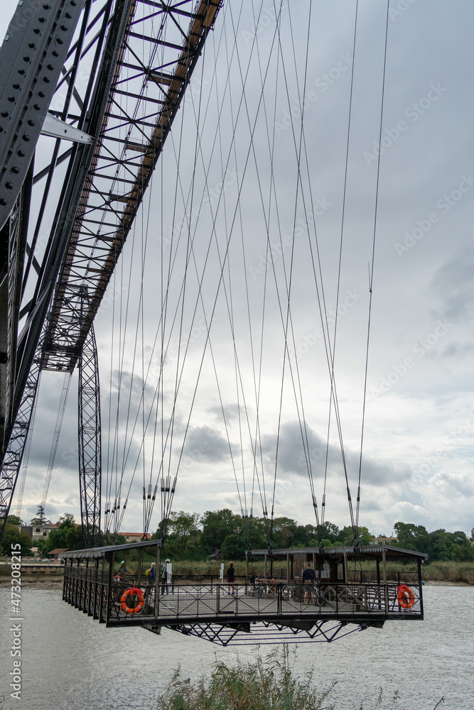 Transporter Bridge over the Charente river under a cloudy sky. National monument. Rochefort sur mer. France Transporter Bridge over the Charente river under a cloudy sky. National monument. Rochefort sur mer. France