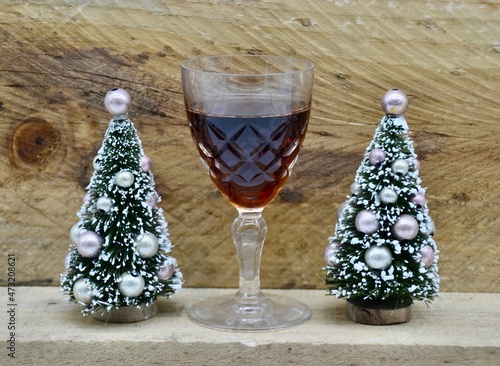 Two decoration Christmas trees on mantel with port wine
