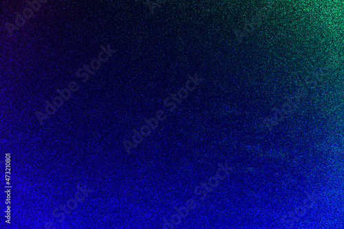 Illuminated neon background. Blue glitter background with green and light blue backlight. Modern trendy backdrop.