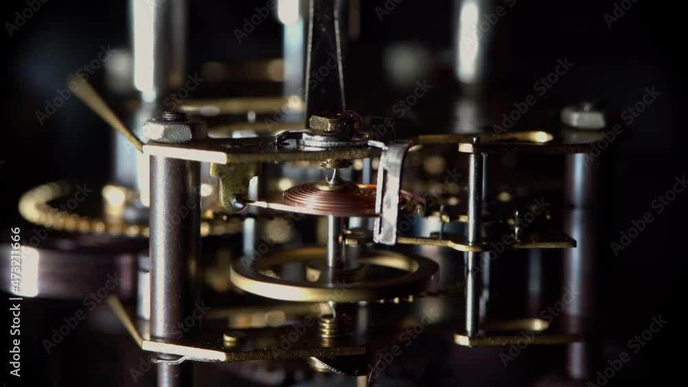 Macro video of the primitive clockwork mechanism of an old desktop alarm clock Macro video of the primitive clockwork mechanism of an old desktop alarm clock