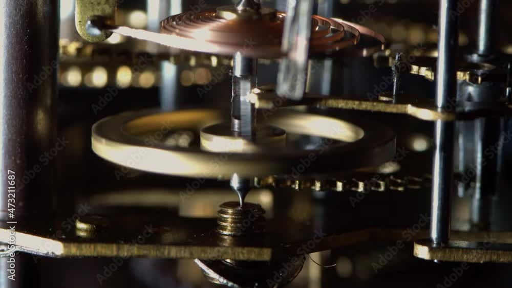 Macro video of the primitive clockwork mechanism of an old desktop alarm clock Macro video of the primitive clockwork mechanism of an old desktop alarm clock
