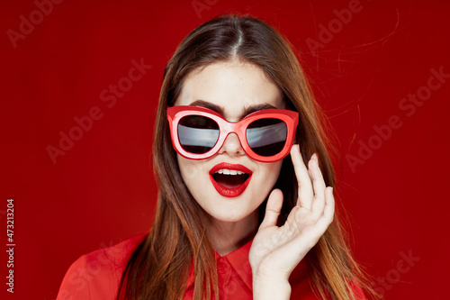 cheerful woman in a red shirt sunglasses Glamor close-up