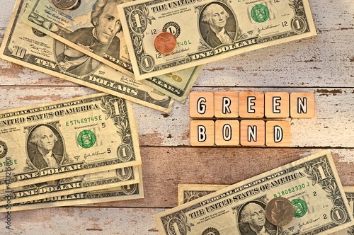 The letters arranged in the word Green Bond. It's on a wood board with bills.