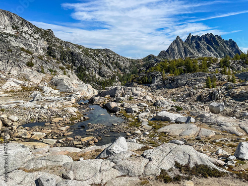 rugged granite rocks in front of jagged mountain peaks