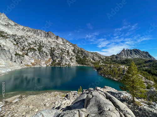 bright blue alpine lake surrounded by granite mountains