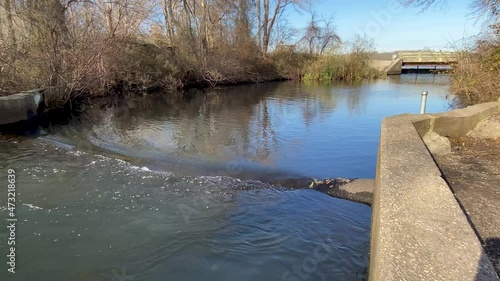 Water flowing out of Southards pond under small bridge into the Carlls River. photo