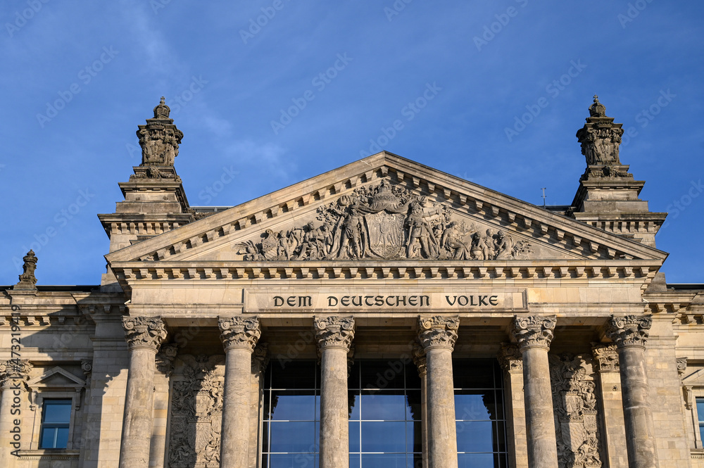 German Bundestag. Berlin, building of German Parliament. National flags flying on a flagpole in a front of Reichstag building in Berlin, Germany. 