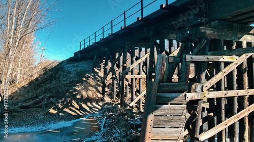 railroad bridge over frozen water in autumn