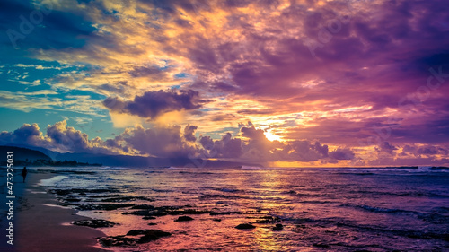 Woman Strolling on Beach during Colorful Sunset over Sunset Beach on Oahu, Hawaii